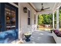 Cozy front porch with swing, ceiling fan, and classic columns create a welcoming and comfortable outdoor space at 1431 Courtland Dr, Raleigh, NC 27604