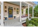 Inviting front porch with a swing, elegant columns, ceiling fan, and ample space for relaxing and entertaining at 1431 Courtland Dr, Raleigh, NC 27604