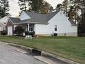 Attractive home showcasing well-kept lawn and garden with blooming bushes at 1454-17 Cimarron Pkwy, Wake Forest, NC 27587