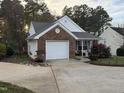Beautiful home with brick accents, a charming front porch, and blooming landscape providing curb appeal at 1454-17 Cimarron Pkwy, Wake Forest, NC 27587