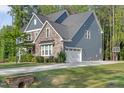 Two-story home with stone and siding, attached garage and a well-maintained lawn at 1520 Banks Brooke Dr, Raleigh, NC 27603