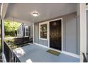 Close up of a cozy covered porch with a classic swing, highlighting a welcoming entrance with elegant details at 1613 Kilmer Ter, Durham, NC 27703