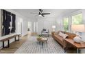 Bright living room featuring hardwood floors, modern decor, and ample natural light, creating a warm atmosphere at 1613 Kilmer Ter, Durham, NC 27703
