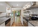 Modern kitchen featuring granite countertops, stainless steel appliances, and subway tile backsplash at 1782 Quail Ridge Rd, Raleigh, NC 27609
