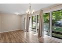 Bright living room featuring large windows, hardwood floors, and a modern chandelier at 1782 Quail Ridge Rd, Raleigh, NC 27609