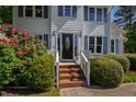 Close up of home's main entrance with brick steps and colorful shrubbery at 2 Great Oak Ct, Durham, NC 27713