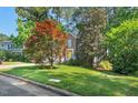 Charming brick home with a yellow front door and well-maintained landscaping at 2018 Waterton Ln, Apex, NC 27502