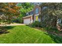 Charming brick home with a yellow front door and well-maintained landscaping at 2018 Waterton Ln, Apex, NC 27502