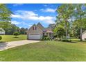 Lovely single-Gathering home with a well-kept lawn, and a spacious front yard with mature trees at 202 Reeder Branch Dr, Clayton, NC 27520