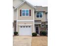 Charming townhouse boasts a single-car garage, well-maintained landscaping, and traditional architectural details at 204 Stockton Gorge Rd. Rd, Morrisville, NC 27560