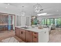 Open-concept kitchen with a large island, modern lighting, and stainless steel appliances at 2104 Manuel St, Raleigh, NC 27612