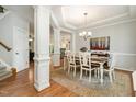 Elegant dining room with detailed trim, a chandelier, and seamless access to other living spaces at 215 Hopesworth Ct, Hillsborough, NC 27278