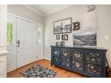 Foyer with hardwood floors, stylish decor, and ample natural light, creating a warm entrance at 215 Hopesworth Ct, Hillsborough, NC 27278