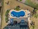 Aerial view of backyard pool, patio with lounge chairs, and landscaped yard at 221 Obsidian Dr, Holly Springs, NC 27540