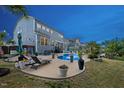 Backyard patio featuring lounge chairs, a dining area and a swimming pool at 221 Obsidian Dr, Holly Springs, NC 27540
