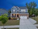 Exterior of a two-story home with a stone facade and manicured front yard at 221 Obsidian Dr, Holly Springs, NC 27540