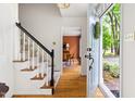 Inviting entryway with hardwood floors, staircase, and a view into the dining room at 2481 Foxwood Dr, Chapel Hill, NC 27514
