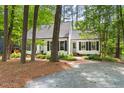 Picturesque home with a brick driveway, surrounded by lush trees for enhanced privacy at 2481 Foxwood Dr, Chapel Hill, NC 27514