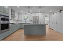 Stylish kitchen featuring a center island, stainless steel appliances and sliding door access at 2505 Catalina Ct, Raleigh, NC 27607