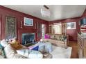 Cozy living room with dark walls, fireplace, hardwood floors, and stylish furniture at 2704 Fairview Rd, Raleigh, NC 27608
