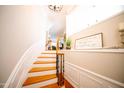 Elegant stairway featuring wood treads, white risers, and decorative iron railing at 2711 Laurelcherry St, Raleigh, NC 27612