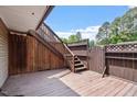 Exterior wood deck and stairs leading to a fenced patio area at 294 Summerwalk Cir, Chapel Hill, NC 27517