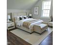Comfortable bedroom with a plush bed, stylish nightstands, and a cozy bench, creating a relaxing retreat at 305 E Harnett St, Benson, NC 27504