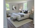 Cozy main bedroom with neutral tones, a luxurious bed, and ample natural light streaming through the windows at 305 E Harnett St, Benson, NC 27504