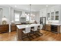 Modern kitchen featuring a large island, stainless steel appliances, and custom cabinetry at 308 Furches St, Raleigh, NC 27607