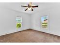 Bedroom featuring natural light from two windows and carpet floors at 310 Chicopee Rd, Benson, NC 27504