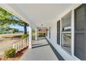 Inviting covered front porch with brick base, offering outdoor comfort and curb appeal at 310 Chicopee Rd, Benson, NC 27504