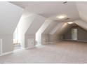 Spacious bonus room with natural light, neutral carpet, and ample storage at 312 Heidinger Dr, Cary, NC 27511