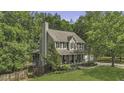 Beautiful two-story home surrounded by lush greenery providing privacy at 3204 Peachford Ln, Raleigh, NC 27616