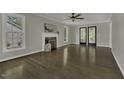 Spacious living room featuring hardwood floors, fireplace, and ample natural light at 3204 Peachford Ln, Raleigh, NC 27616