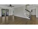 Open-concept living room with hardwood floors and staircase access at 3204 Peachford Ln, Raleigh, NC 27616