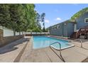Backyard pool featuring a patio, spa, and well-maintained white fence at 3704 Swann St, Raleigh, NC 27612