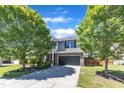 Beautifully landscaped front exterior featuring mature trees and a spacious driveway leading to the two-car garage at 3801 Althorp Dr, Raleigh, NC 27616