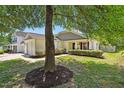 Inviting single-story home with lush lawn, decorative shrubs, and neutral siding at 3808 Hopper St, Raleigh, NC 27616