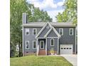 Charming two-story home with a well manicured lawn and attached garage at 404 Cary Pines Dr, Cary, NC 27513