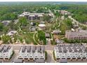 Breathtaking aerial view showcasing a meticulously landscaped community park surrounded by modern townhomes at 411 Flat Rail Trl, Cary, NC 27511