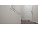 Bright entryway with hardwood floors, white door with digital lock and a staircase at 412 Ember St, Sanford, NC 27330