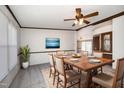 Elegant dining room featuring a wooden table set for six, complemented by a modern ceiling fan at 43 Columbus Ct, Spring Lake, NC 28390