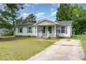 This one-story home features neutral siding, green shutters, and a small front porch at 43 Columbus Ct, Spring Lake, NC 28390
