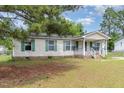 One-story home with light siding, green shutters, brick foundation and covered porch at 43 Columbus Ct, Spring Lake, NC 28390