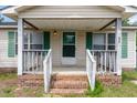 Close up of front porch with steps, railing, weathered door and windows at 43 Columbus Ct, Spring Lake, NC 28390