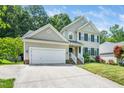 Charming two-story home features a two-car garage, landscaped yard, and welcoming front porch at 437 New Parkside Dr, Chapel Hill, NC 27516