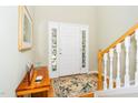 Bright foyer with hardwood floors, decorative sidelights, and a staircase at 437 New Parkside Dr, Chapel Hill, NC 27516