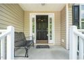 Inviting front porch with detailed sidelights, a bench, and ample space for relaxing at 437 New Parkside Dr, Chapel Hill, NC 27516