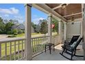 Inviting front porch with rocking chairs and a view of the well-maintained neighborhood at 5117 Dove Forest Ln, Apex, NC 27539