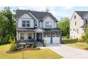 Charming two-story home with stone accents, a covered porch, and a well-manicured lawn at 521 Marion Hills Way, Knightdale, NC 27545